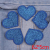 A set of five blue glitter heart iron-on embroidered patches on denim fabric.