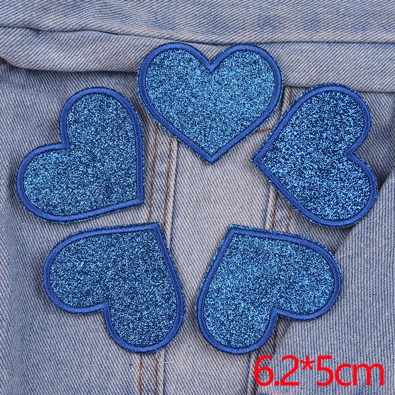 A set of five blue glitter heart iron-on embroidered patches on denim fabric.