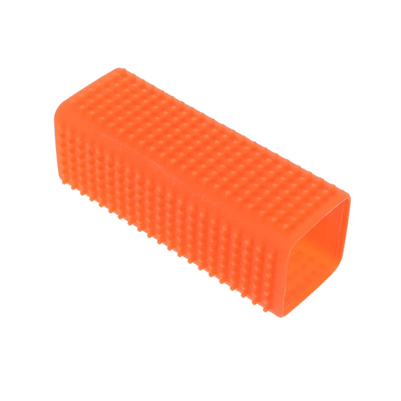 Orange silicone pet hair remover brush with a textured surface