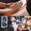 Hands are applying tattoo practice skin and thermal transfer paper to a person's skin.