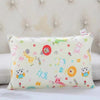 A light yellow cartoon patterned pillowcase featuring various cute animal characters and shapes.