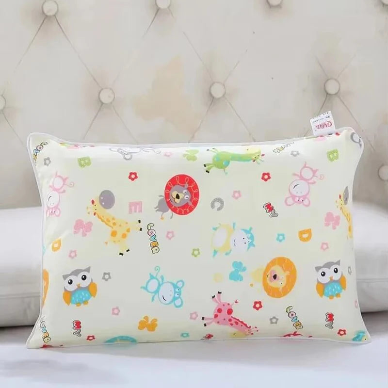 A light yellow cartoon patterned pillowcase featuring various cute animal characters and shapes.