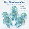 A set of three blue transparent glitter squishy toys made of soft material for stress relief and fidgeting.