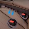A pair of car seat gap filler organizers with grooves are shown inside a car seat upholstery.