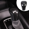 Close-up of a black carbon fiber gear shift knob cover for a Toyota Camry or Corolla.