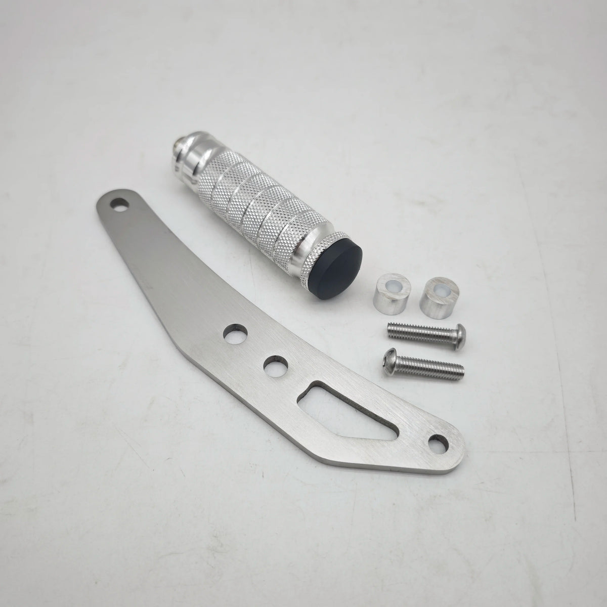 A set of CNC aluminum foot pegs and mounting hardware for electric dirt bikes.