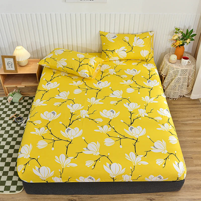 Yellow fitted bed sheet with a white floral pattern displayed on a bed.