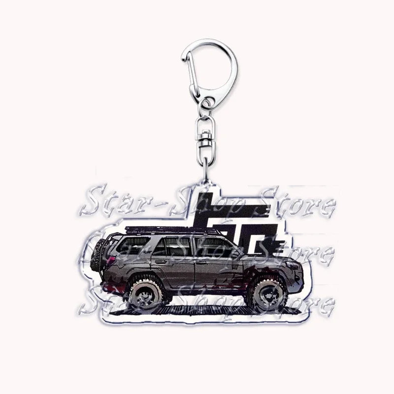 A silver metal key ring attached to a durable keychain featuring an off-road truck silhouette.