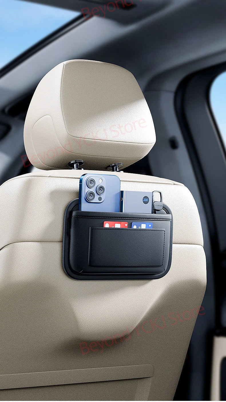 A light beige car seat organizer bag with a smartphone mounted on top, designed for storage in a car's side pocket.