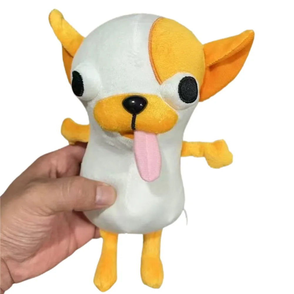 A white and orange plush chihuahua dog figure being held in a person's hand.