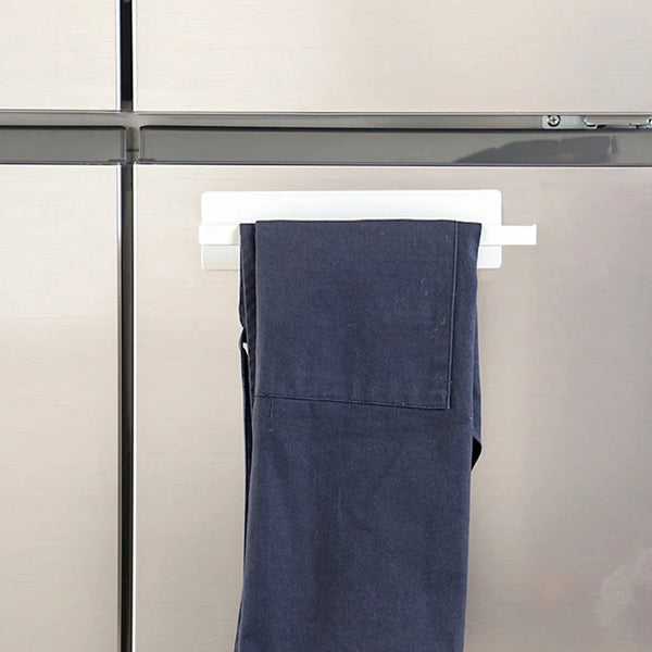 A dark blue magnetic paper towel holder mounted on a stainless steel refrigerator door.