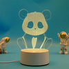 A clear acrylic 3D illusion LED night light lamp shaped like a panda, resting on a white base.