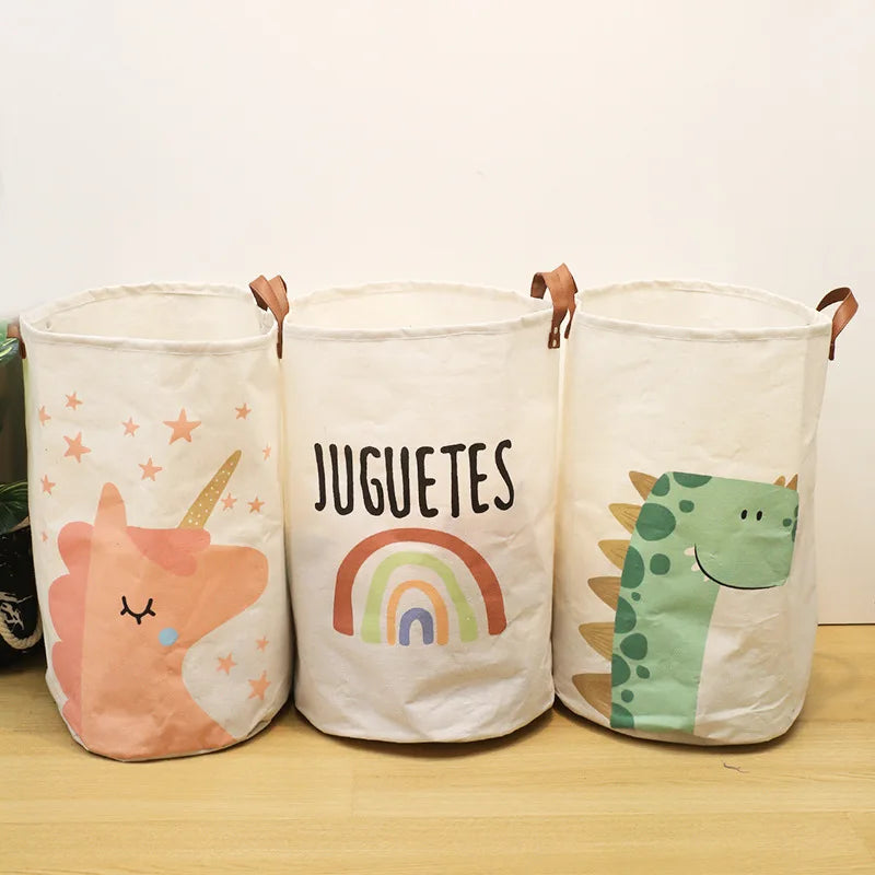 Three white fabric storage baskets with colorful dinosaur and rainbow prints for baby items