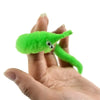 A bright green magic slithering caterpillar trick is held in a person's hand.