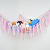Bohemian handwoven corner toy storage net with pink and blue tassels featuring cute animal figures