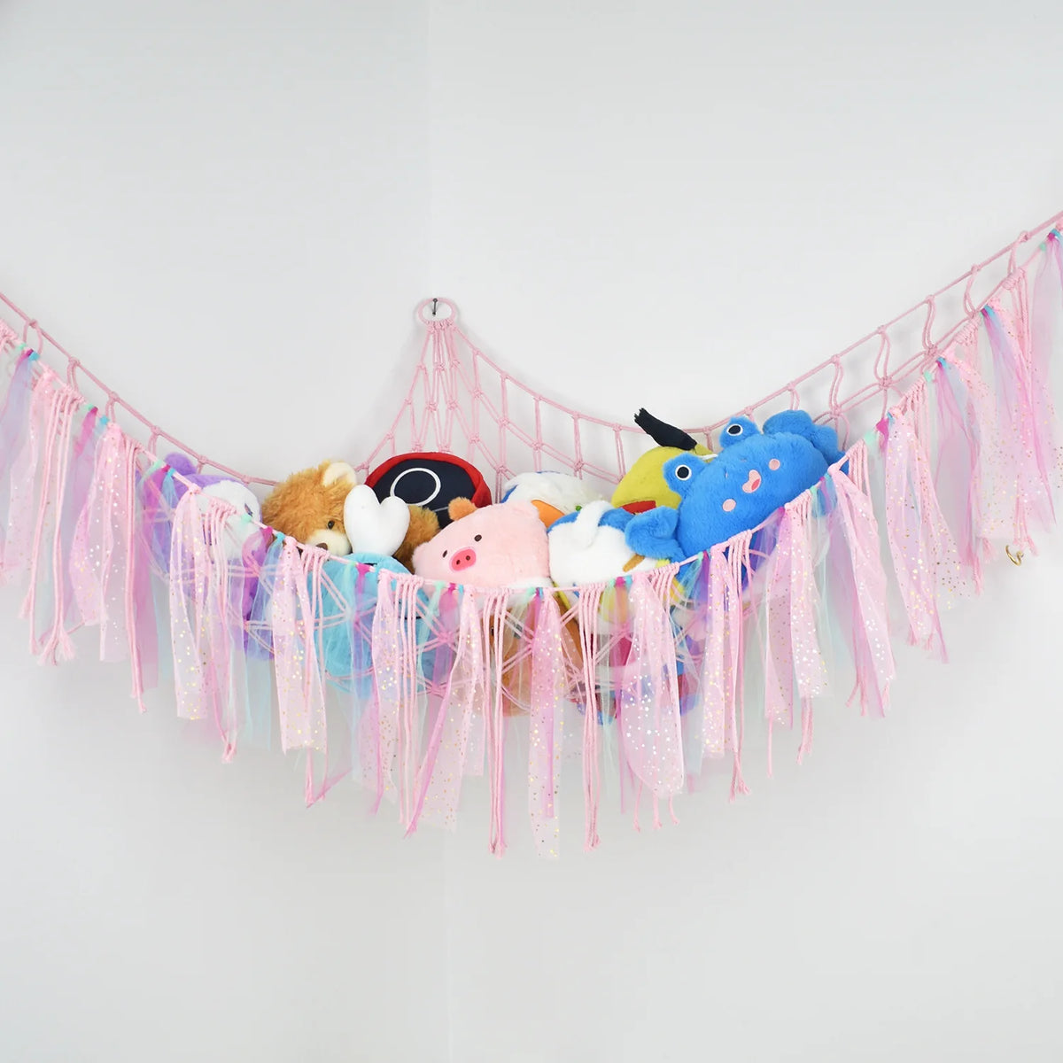 Bohemian handwoven corner toy storage net with pink and blue tassels featuring cute animal figures