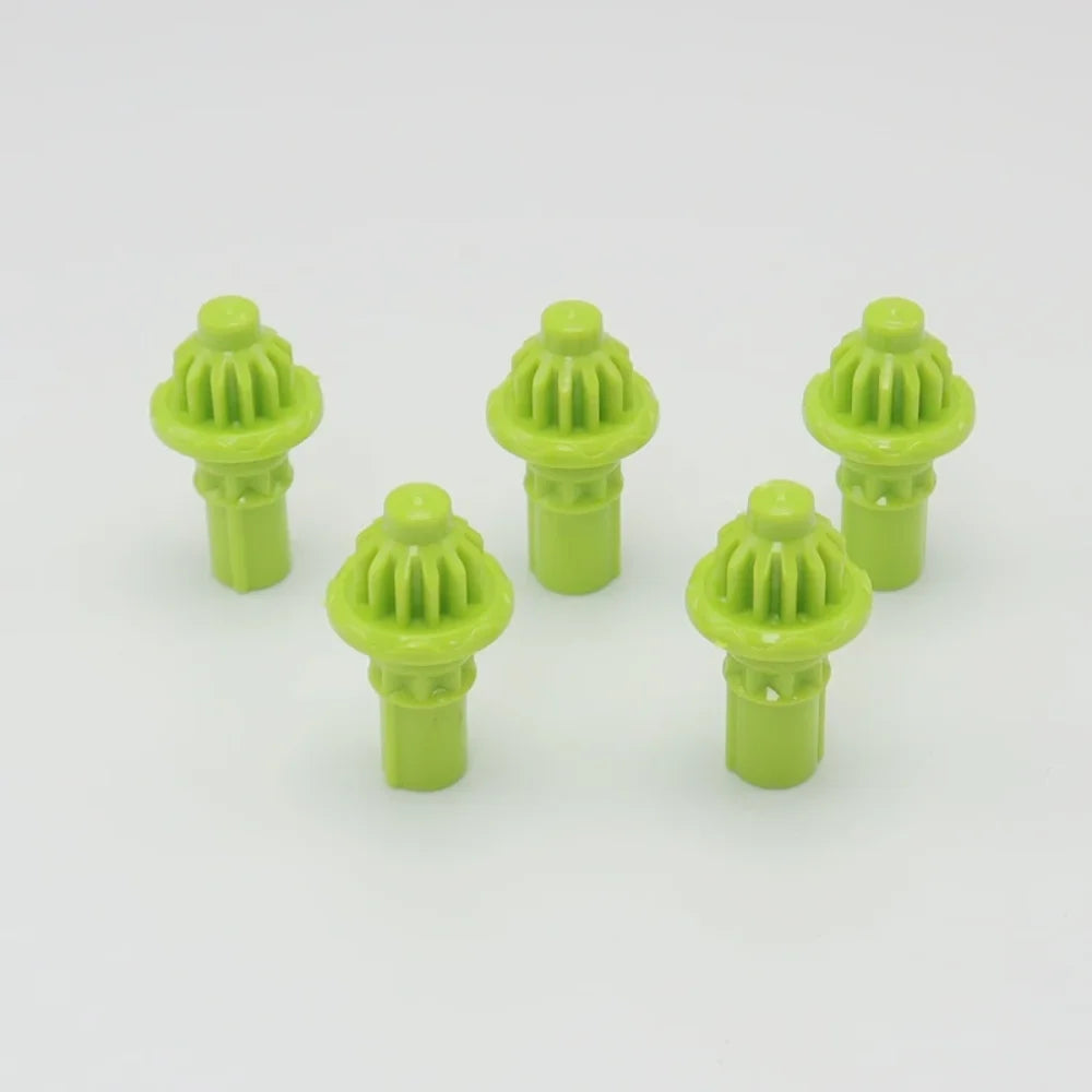 A set of five lime green replacement drivers for a Battling Top, used to replace damaged original parts.