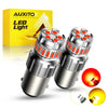 A pair of bright LED light bulbs for automotive use, shown next to its packaging and a disassembled bulb.