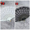 A pair of vintage lace folding hand fans in white and black, shown with red flowers, measuring 45cm/17.7in.