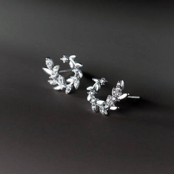 Sterling silver leaf stud earrings with small, delicate leaves.