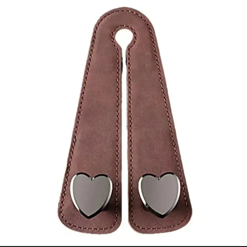 A brown leather car seat headrest hook with dual hooks for bags and phones.