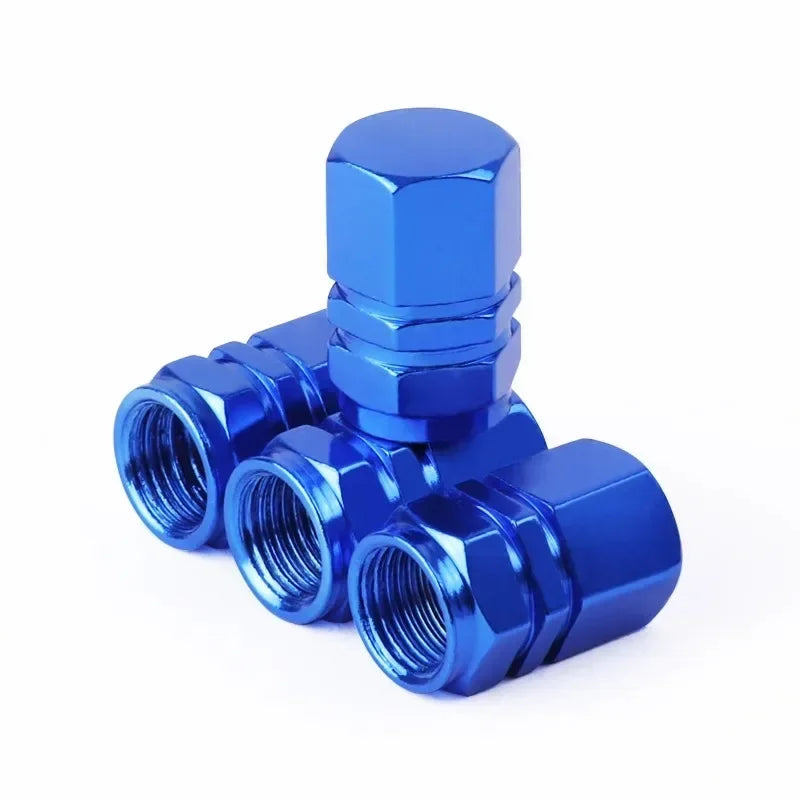 A set of four blue aluminum alloy wheel tire valve caps with a hexagon design.