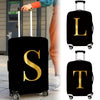 Black luggage with a gold letter S and T print on the side