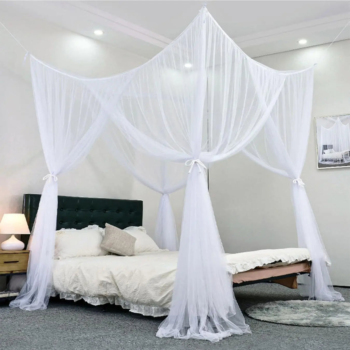 White sheer mosquito net draped over a bed frame in a bright room.