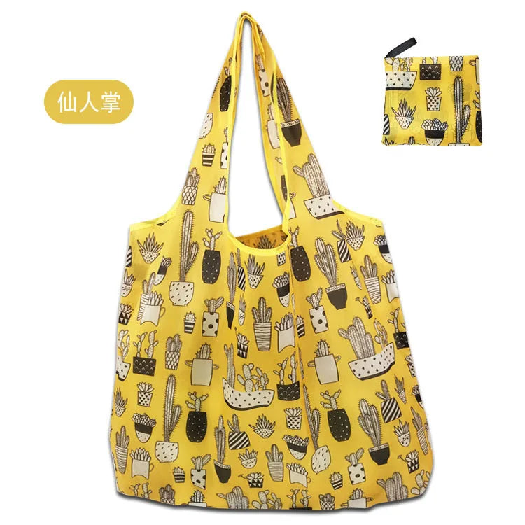 A yellow reusable shopping tote bag patterned with various cacti and succulents.
