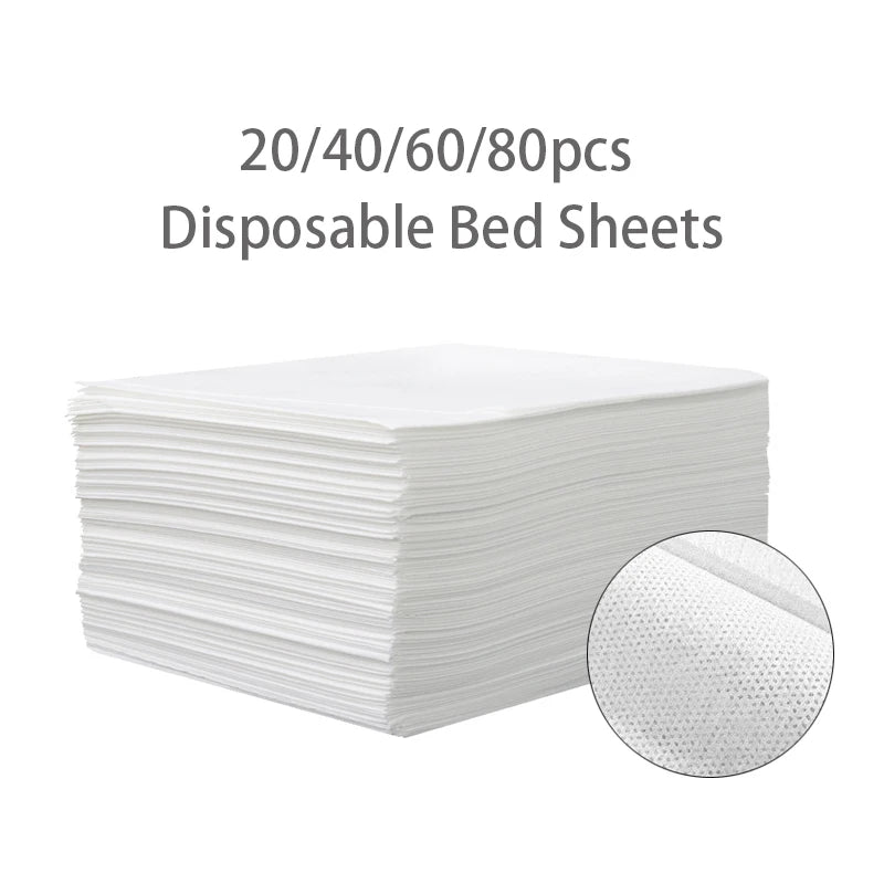 A stack of white disposable bed sheets, packaged in quantities of 20, 40, 60, and 80 pieces.