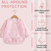 Pink all-around protection baby outfit featuring waterproof fabric, a food catcher pocket, and elastic cuffs.