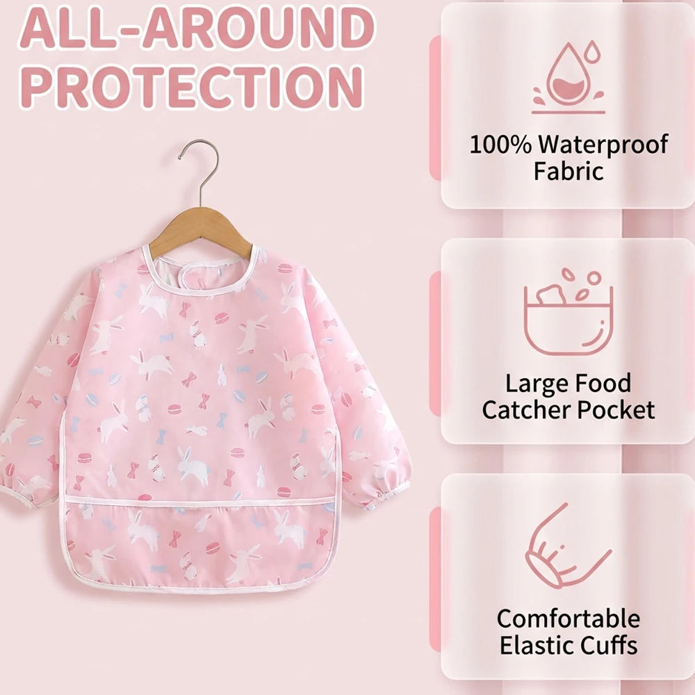 Pink all-around protection baby outfit featuring waterproof fabric, a food catcher pocket, and elastic cuffs.