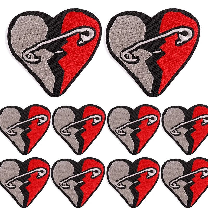 A set of ten heart-shaped embroidered iron-on patches featuring a cracked rock skull design in gray and red.