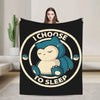 A black throw blanket featuring a graphic of a sleeping blue cartoon bear with the text I choose to sleep.