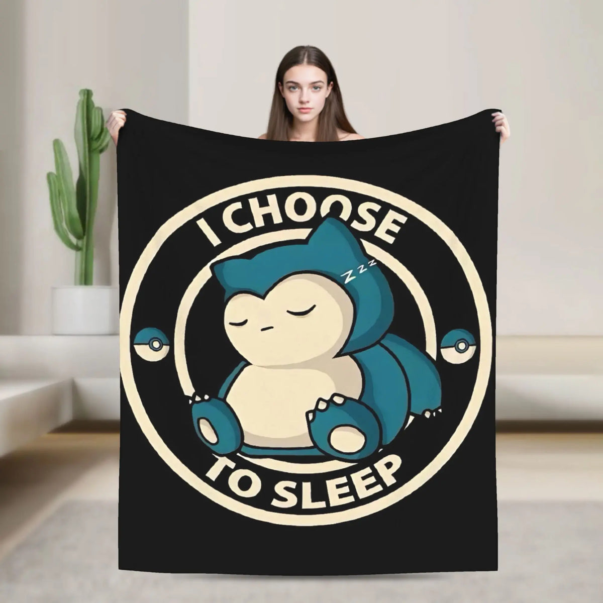 A black throw blanket featuring a graphic of a sleeping blue cartoon bear with the text I choose to sleep.
