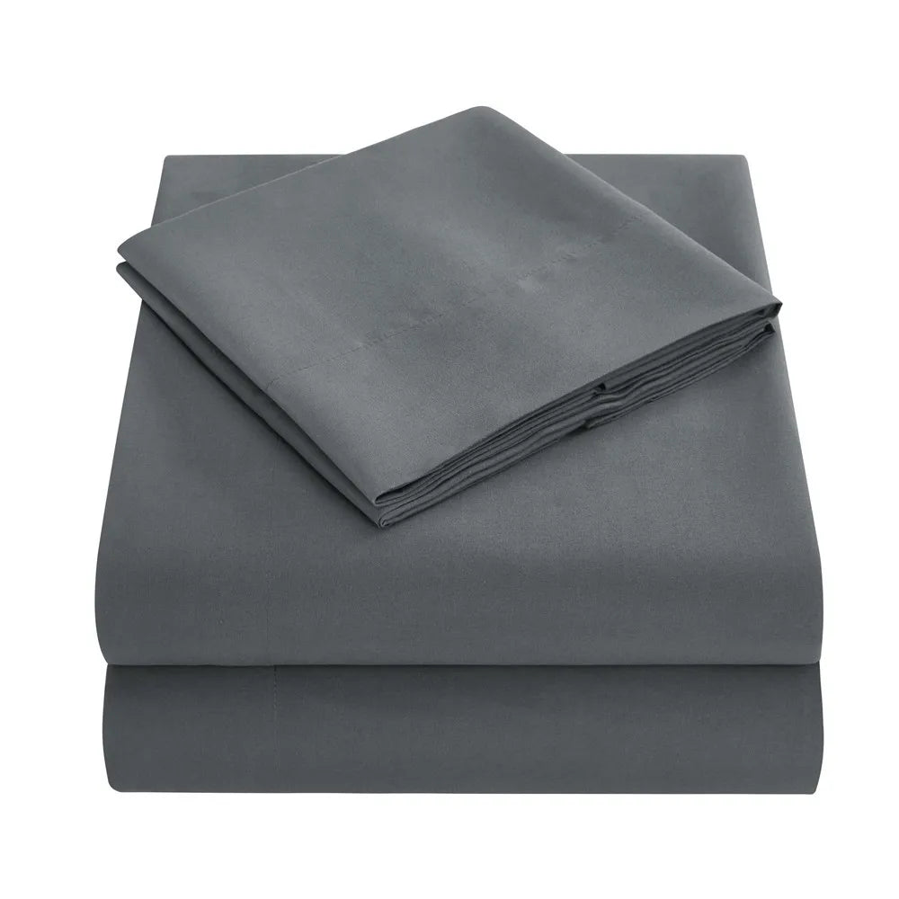 A stack of gray soft brushed microfiber bedding including a fitted sheet, flat sheet, and pillowcases.