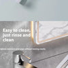 A silicone scraper broom and squeegee used for cleaning, shown next to a marble surface.