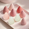 A collection of pink and white rose bloom silicone molds shaped like petals, resting on a light pink tray.