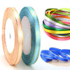 Rolls of gold-edge satin ribbon in various colors, including teal and yellow, for crafts and decor.