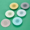 Five circular silicone sink drain filters in various pastel colors including yellow, gray, white, and pink