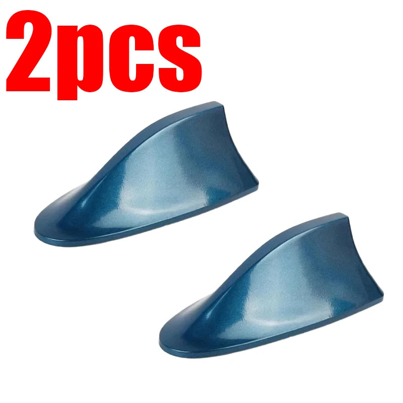 Two blue shark fin car antennas for FM/AM signal enhancement