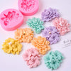 Assortment of pink, purple, and peach silicone molds shaped like frangipani gardenia flowers for candle and soap making