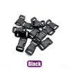 A pile of black plastic side-release buckles for paracord bracelet projects.