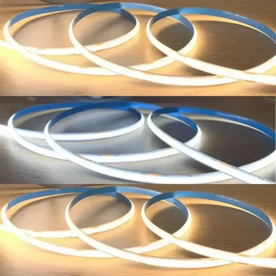 A close-up of a white LED strip light with blue accents forming concentric circles, illuminated against a wooden background.