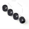 A row of black crystal-cut tire valve caps, sparkling under light.