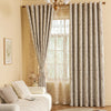 A pair of beige and gray striped blackout curtain panels with a plant pattern hanging in a window.