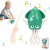 A green squid-shaped toy with tentacles and a light show is shown next to a baby and a light wand.