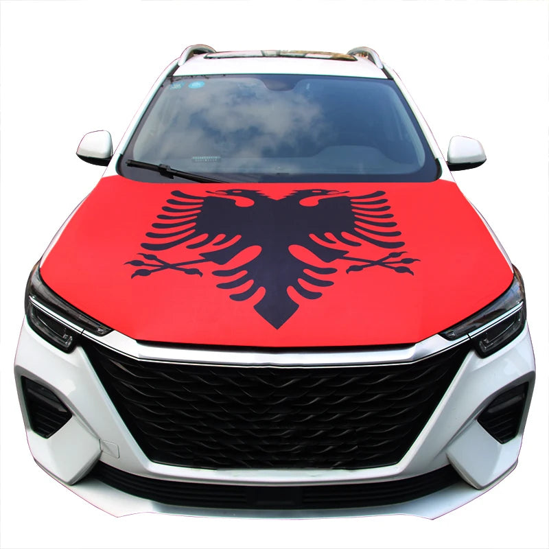 A white car with a red hood cover featuring a black Polish eagle design.