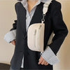 A woman wearing a black blazer and striped shirt holds a cream-colored multi-pocket PU leather waist bag with an adjustable s