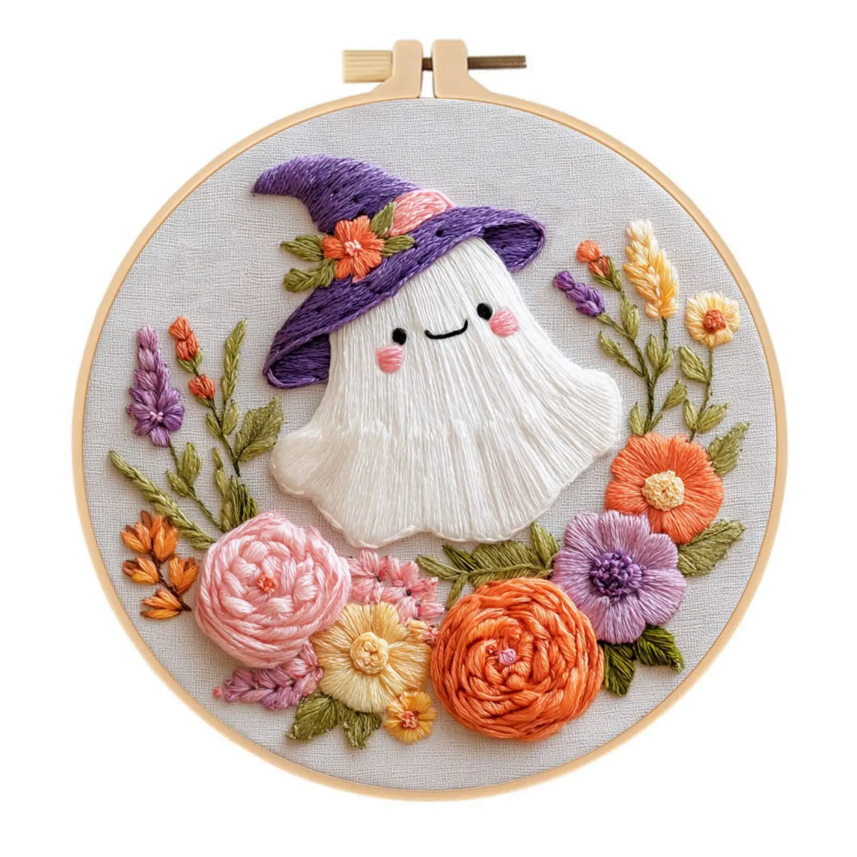 A cross stitch kit featuring a purple hat and floral embroidery on a light background.